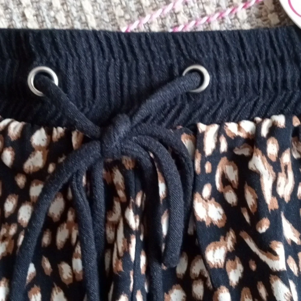 Umgee medium animal print front, solid black cheeky shorts with fringed hem. NWT - Picture 2 of 7